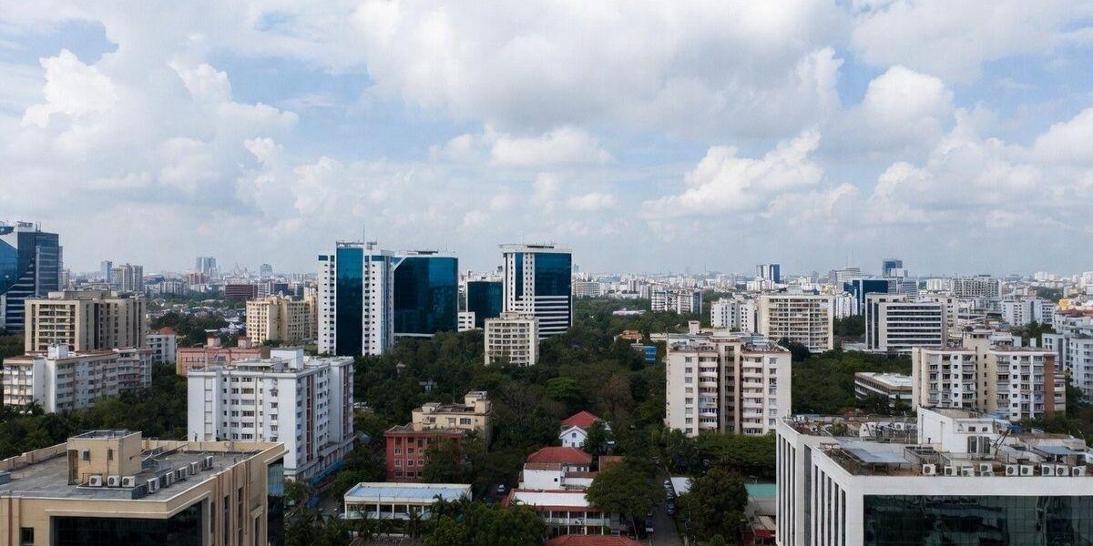 "Modern Bangalore skyline featuring residential towers, commercial buildings, metro connectivity, and rapidly developing real estate corridors across the city."